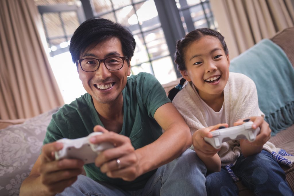 Father and Daughter playing video game